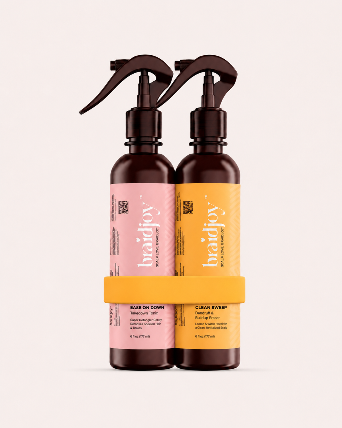Two amber braidjoy spray bottles in a yellow holder, featuring Clean Sweep scalp refresher and Ease on Down detangler for gentle braid takedowns, buildup removal, and smoother wash days.